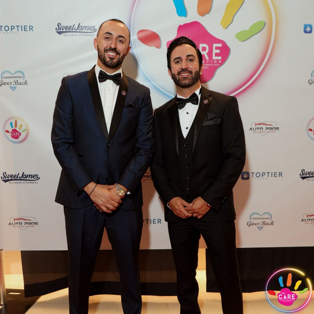 Co-founders George Papamatheakis and Roni Warda in tuxedos at a CARE gala
