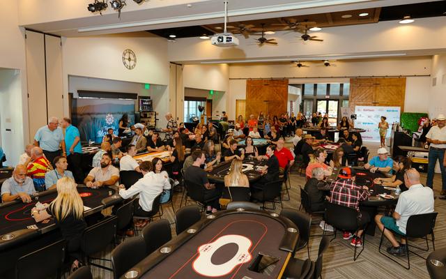 A full room of players at the poker tables at the 2nd Annual Summer Poker Tournament.