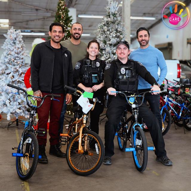 Volunteers and an officer with new bikes for kids