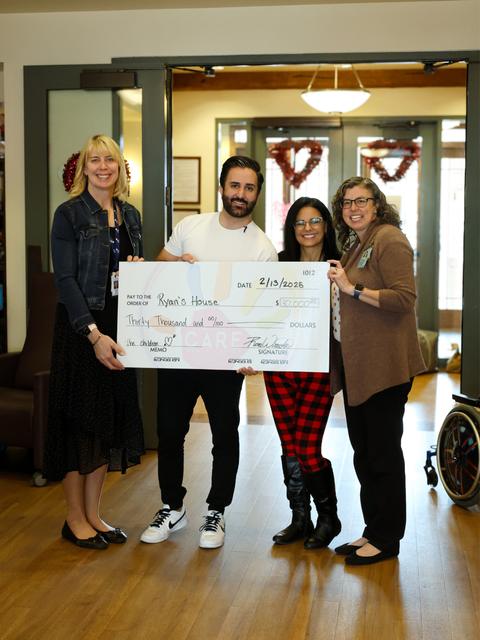 The CARE team presenting a big donation check